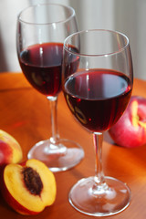 Two glasses with red wine with peaches