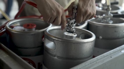 Hooking up pipe to beer keg bung at Summer festival