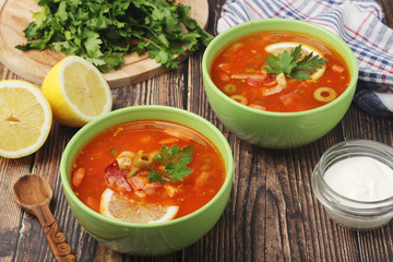 Two bowls with traditional Russian soup solyanka