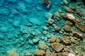 Naklejka na ściany i meble turquoise Ionian Sea water, stones and rocks at Porto katsiki beach on Lefkada Island, Greece. Beautiful landscape.