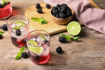 Delicious refreshing blackberry lemonade on wooden table