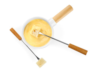 Pot of tasty cheese fondue and forks isolated on white, top view