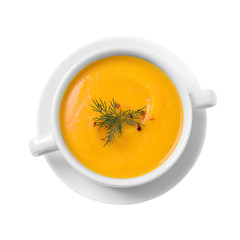 Delicious pumpkin soup in bowl on white background, top view