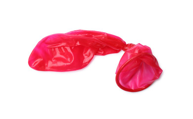 Red used condom on white background. Safe sex concept