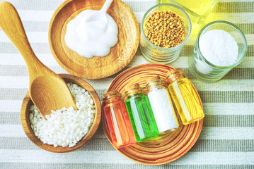 Closeup apothecary organic oil product with salt and liquid lotion decorate with spa product on the table.