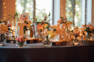 on festive table in wedding banquet. the table is decorated with compositions of greenery