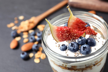 Tasty homemade granola dessert on dark grey table, closeup. Healthy breakfast