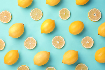 Flat lay composition with fresh lemons on turquoise background