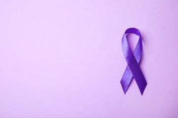 Purple ribbon on lilac background, top view with space for text. Domestic violence awareness - obrazy, fototapety, plakaty