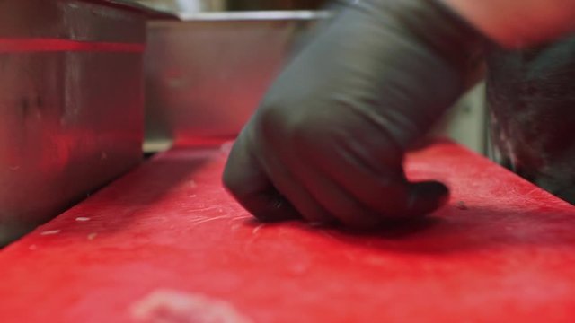 Cook makes escalope with pork fillet in restaurant kitchen closeup