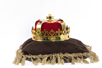king crown on a pillow isolated a white background