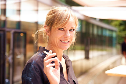 Middle Aged Woman Smoking Cigarette While Standing Outdoor