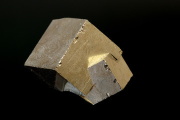 macro mineral pyrite stone on a black background
