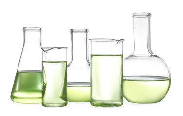 Glassware with liquids isolated on white. Laboratory analysis