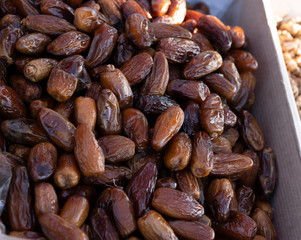 Dates fruit on counter for sale.