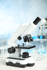 Modern microscope on table in laboratory. Medical equipment