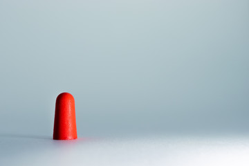 Red vivid ear plug in the lightbox