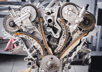 Parts of a disassembled car engine organised on the table for the period of repair