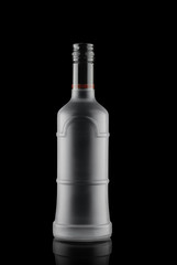 frosted glass bottle, with alcohol, on black background