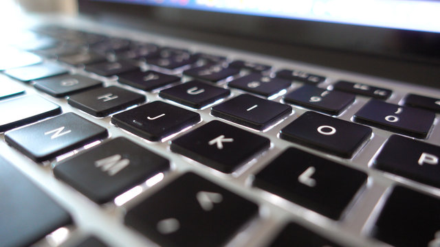 Photography close up shot of used laptop computer or notebook keyboard keys