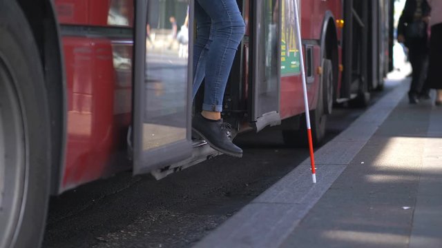 Blindness,indipendence,autonomy.Blind person getting off the bus