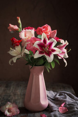 still life with summer flowers in vase on dark background