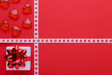 red background with gift box and hearts, copy space