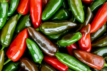 Pile of jalapeno peppers in various stages of maturation in the market