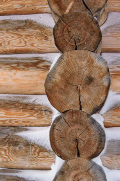 detail of wooden house construction, wooden logs covered with snow, european alpine architecture