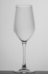 Empty wine glass on a white background. Black and white photo.  Closeup