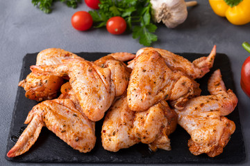 Raw marinated chicken  wings in red sauce ready to cook.