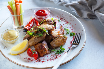 Delicious chicken wings  with  celery and carrot sticks.