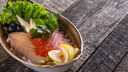 Cold appetizer with salted salmon and halibut on a plate  with copy space