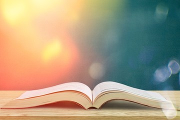 Ancient books in a row on wooden background