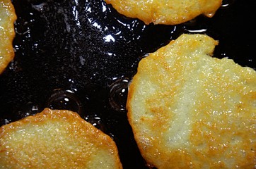 Fried potato pancakes in a frying pan. Ready lunch (Breakfast) or dinner. The view is very close.