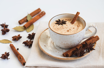 Indian Masala chai tea. Traditional Indian hot drink with milk and spices on white background...