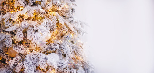 Christmas white tree decorated snow illumination and gifts toys, background light bokeh, silver color
