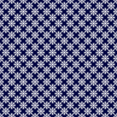 Seamless pattern. Little white snowflakes on a blue background. Vector drawing. Texture.