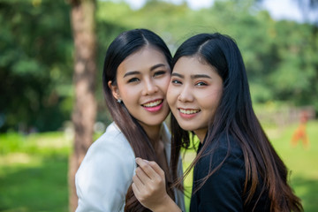 Two women joyful together in park 