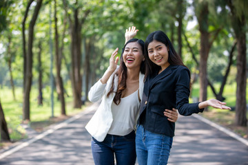 Two women joyful together in park 
