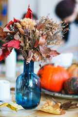 The table is decorated with pumpkins for Halloween.