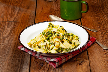 Spaghetti with spinach and bacon.