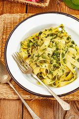 Spaghetti with spinach and bacon.