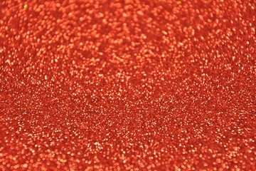 Blurred abstract background with sparkle shiny bokeh. Romantic holiday bokeh background with soft focus and magical shimmering. Christmas and new year card. Red bokeh backdrop 