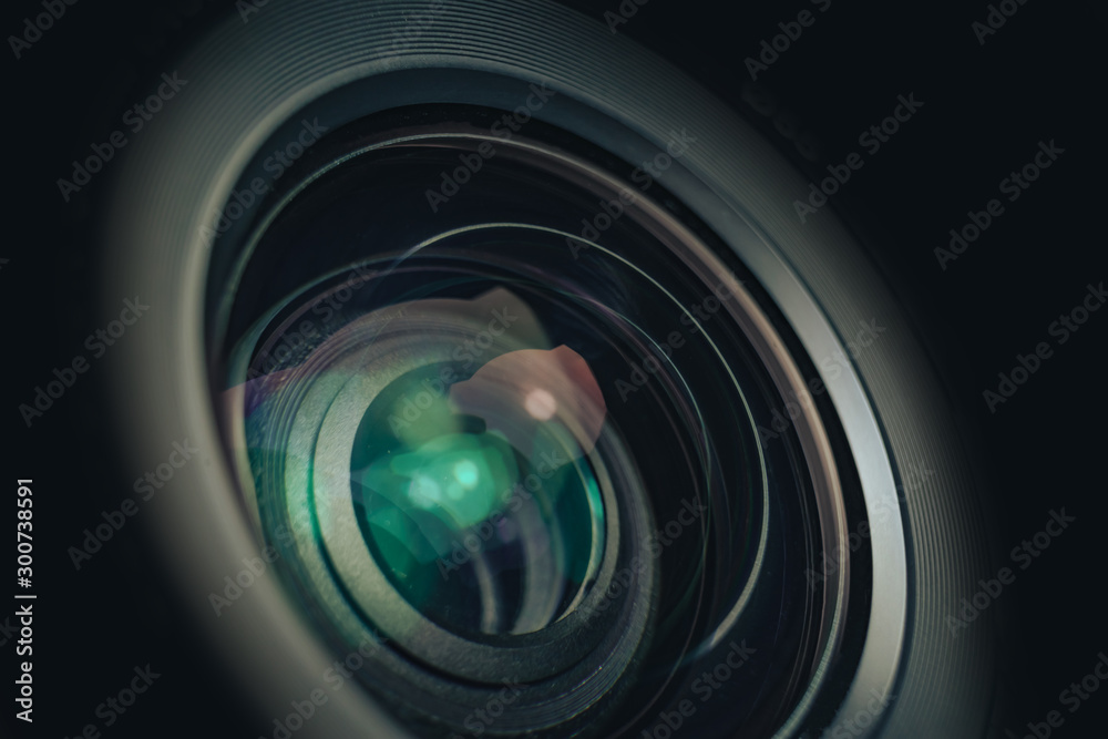 Poster close up beautiful camera lens on a black background. macro view..