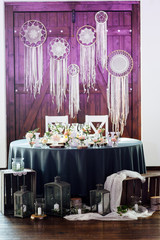 Wedding floral table decoration with candles in transparent vases