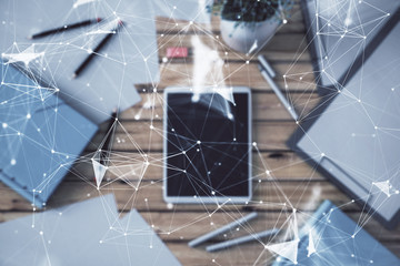 Double exposure of technology theme drawing on digital tablet laying on table background. Concept of hightech