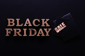 Black friday sale concept. Fourth Friday of November, beginning of Christmas shopping season since 1952. Price tag with text on paper textured background. Copy space, close up, top view, flat lay