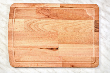 Empty wooden kitchen cutting board made of birch.