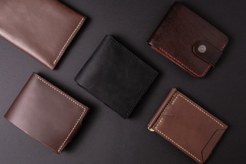 leather wallets on a black background with space for an inscription. Leather craft concept.